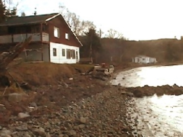 Home by the water. This is a picture of the bungalow, long after it was put up for sale. Everything looks so lonely, and worn --- all the kids have gone. None of us go there anymore; it belongs to other people now.